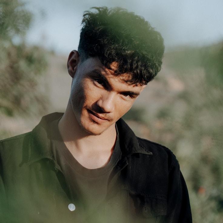 Avery Chen, Lead Design Curator at Grain Forest Candle, reviewing corporate floral arrangements